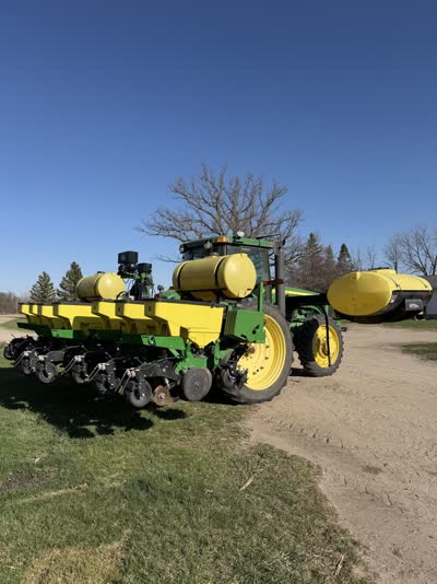 Tractor and twelve-row planter on bare spring ground
